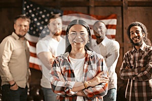 Diverse Group Of American Patriots Standing Against Background Of American Flag