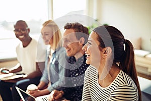 Diverse businesspeople laughing together during an office presen photo