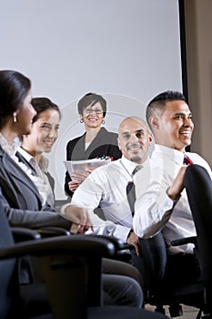 Diverse group businesspeople watching presentation