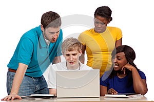 Diverse group of college students/friends looking at a computer