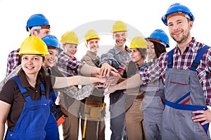 Diverse group of construction workers stacking hands photo