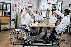 Diverse group of doctors smiling gesturing after meeting