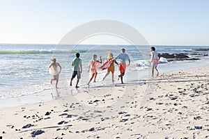 Diverse group of friends enjoy a day at the beach, with copy space