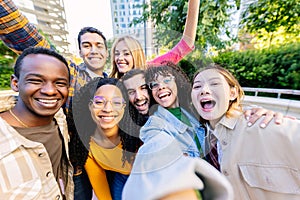 Diverse group of friends enjoying time together at city taking selfie portrait