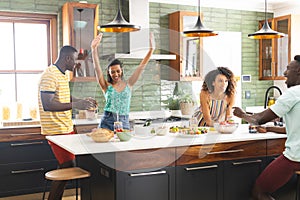 Diverse group of friends enjoys cooking together in a modern kitchen