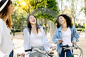 Diverse group of girl friends laughing together having fun on summer vacation