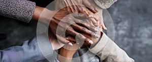 The diverse group of hands stacked in unity and teamwork gesture.AI generated image