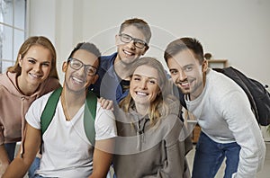 Diverse group of happy college or university friends looking at the camera and smiling