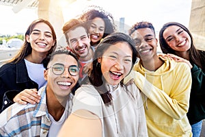 Diverse group of happy young best friends having fun taking selfie together