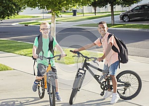 Diverse group of kids riding their bikes to school together photo