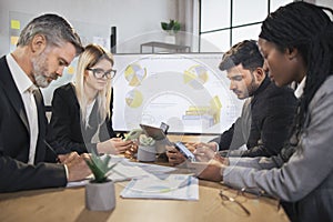 Diverse group of multiracial business people in the conference room with big TV screen