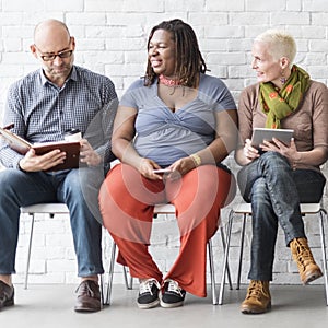 Diverse Group of People Community Togetherness Technology Sitting Concept photo