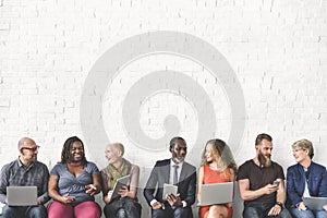 Diverse Group of People Community Togetherness Technology Sitting Concept