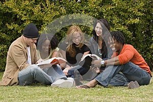 Diverse group of people reading and studying.