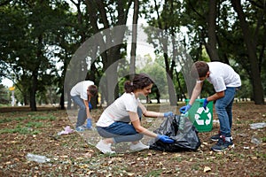 Diverse group of people team with recycle project, picking up trash in the park volunteer community service