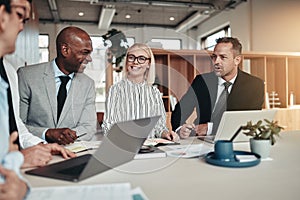 Diverse group of smiling businesspeople working around an office