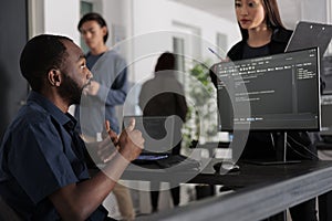Diverse group of web developers analyzing html code and comparing data script