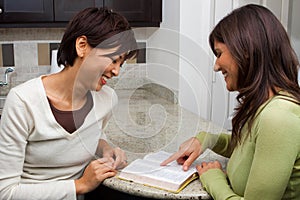 Diverse group of women reading and talking.