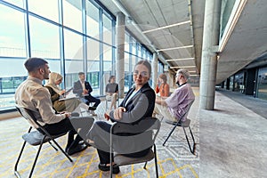 A diverse group of young business entrepreneurs gathered in a circle for a meeting, discussing corporate challenges and