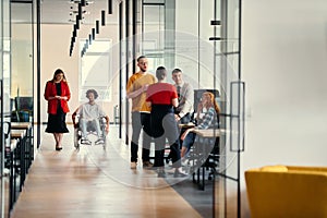 A diverse group of young professionals, including businesswomen and an African-American entrepreneur in a wheelchair