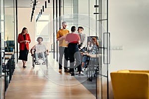 A diverse group of young professionals, including businesswomen and an African-American entrepreneur in a wheelchair