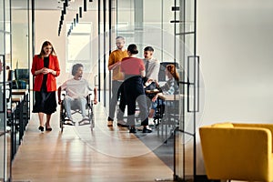 A diverse group of young professionals, including businesswomen and an African-American entrepreneur in a wheelchair