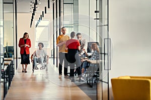 A diverse group of young professionals, including businesswomen and an African-American entrepreneur in a wheelchair