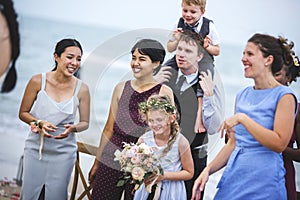Diverse guests enjoy beach wedding party