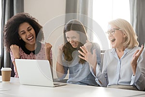 Diverse happy overjoyed female employees team excited by online win