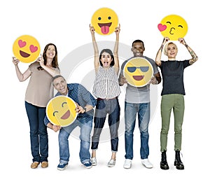 Diverse happy people holding happy emoticons