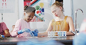 Diverse happy schoolchildren having science class in school lab