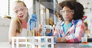 Diverse happy schoolchildren having science class in school lab