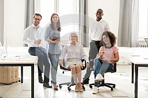 Diverse happy staff employees group posing for portrait in office photo
