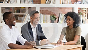 Diverse hr managers laughing listening to african applicant at interview