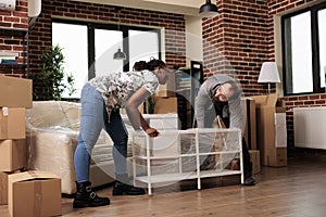 Diverse husband and wife decorating new rented flat to move in