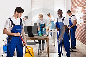 Diverse Janitors Cleaning The Office