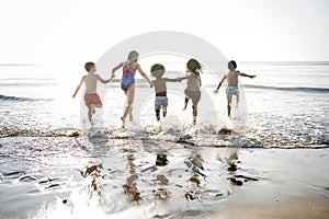 Diverse kids running at the beach