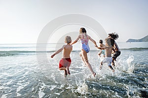 Diverse kids running at the beach