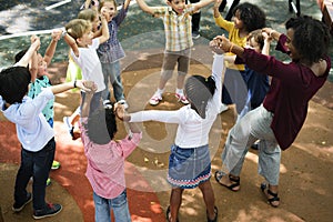 Diverse kindergarten kids arms raised photo