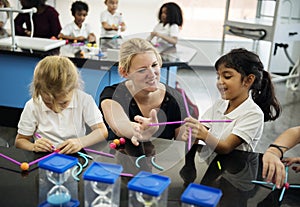 Diverse kindergarten students holding learning structures from t