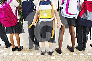 Diverse kindergarten students standing together in scho