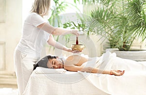 Diverse masseuse and client during sound therapy