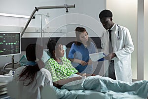 Diverse medical team consulting african american patient