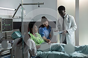 Diverse medical team consulting african american patient