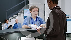 Diverse medical team talking about healthcare at reception desk