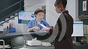 Diverse medical team talking about healthcare at reception desk