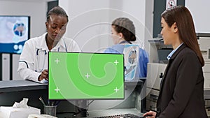 Diverse medical team using computer with greenscreen