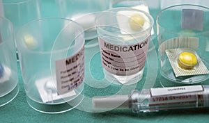 Diverse medication in glasses monodose along with heparin injectors in hospital