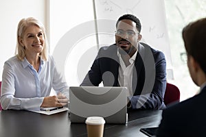 African and mature HR managers listening applicant during job interview photo