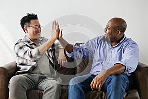 Diverse men joining hands together